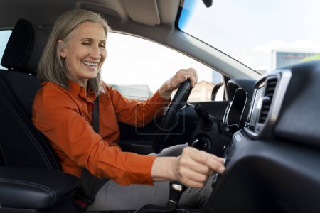 Photo for Portrait of happy confident mature woman driving new car. Road trip, car sharing, transportation concept - Royalty Free Image