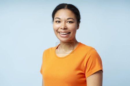 Photo for Portrait of smiling confident African American businesswoman looking at camera isolated on blue background. Successful business, career concept - Royalty Free Image