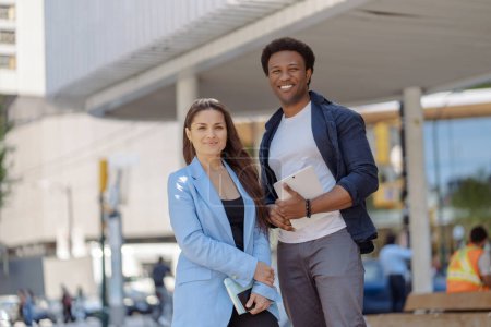 Photo for Portrait of african american man and caucasian woman, business colleagues at city street looking at camera. Concept of successful business, career - Royalty Free Image