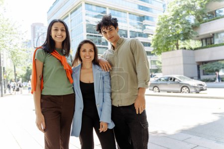 Photo for Smiling positive young students standing looking at camera on street. Successful education, business concept, teamwork - Royalty Free Image