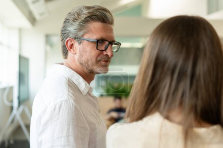 Photo for Portrait of attractive confident gray haired businessman, manager wearing stylish eyeglasses, talking with colleague. ?oncept of successful consultant - Royalty Free Image
