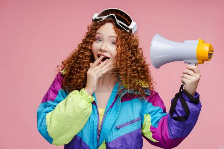 Photo for Attractive excited curly smiling woman holding megaphone, looking at camera, closeup, isolated on pink background. ?oncept of advertisement, shopping - Royalty Free Image