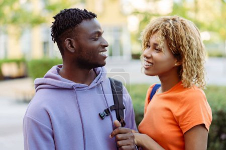 Photo for Smiling African American young couple in love, man and woman, friends talking on the street, outdoors. Concept of love, relationship - Royalty Free Image