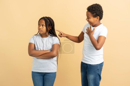 Photo for Upset African American girl and boy, little brother apologizing to his little sister. Concept of family, relationships - Royalty Free Image