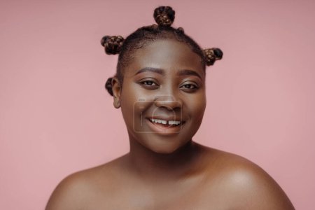 Photo for Portrait of beautiful authentic African plus size model looking at camera isolated on pink background. Attractive female posing for picture, beauty concept, skin care - Royalty Free Image