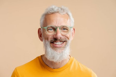 Photo for Closeup portrait handsome smiling mature man with white teeth wearing stylish hipster eyeglasses looking at camera isolated on background. Happy gray haired bearded male after barbershop service - Royalty Free Image