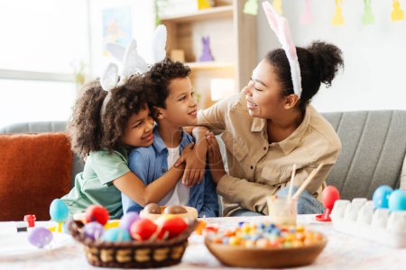 Photo for Portrait happy family : mother and cute kids wearing bunny ears hugging looking each other celebration Easter at home - Royalty Free Image