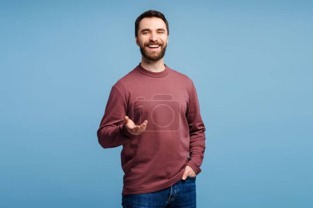 Photo for Portrait smiling handsome bearded man, hipster looking at camera isolated on blue background. Happy confident middle aged businessman, worker, freelancer standing. Successful business - Royalty Free Image