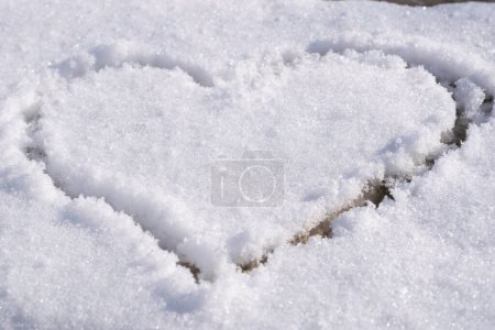 Photo for Heart outlined on snow, symbol of love, snow background - Royalty Free Image