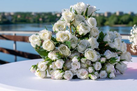 Photo for Bouquet of white bridal flowers on the table at the wedding event - Royalty Free Image
