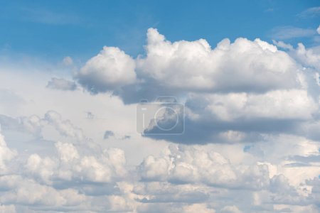 Blue sky background with many clouds. Natural aerial landscape.