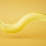 a large deformed banana on a yellow background. 3D render.