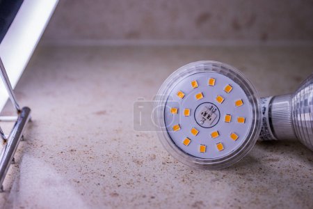 Photo for Led light bulb with yellow and white stripes GU10 base type connection - Royalty Free Image