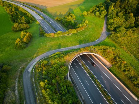Photo for Aerial view of a green overpass over almost empty highway. - Royalty Free Image