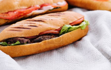 Photo for Three fresh sub sandwiches on a cloth background - Royalty Free Image