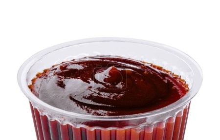 plastic dish of barbecue sauce on white background