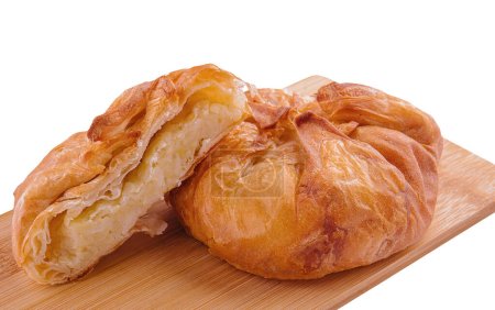 Baking puff pastry vertuta with potatoes on wooden