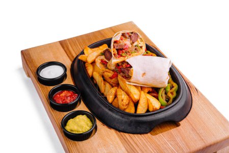 Photo for Beef veggie wrap with french fries and vegetables - Royalty Free Image