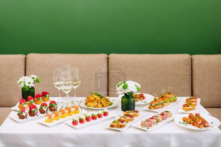Photo for Table with different gourmet snacks for white wine - Royalty Free Image
