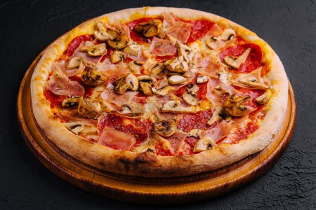 Photo for Pizza with ham, salami and mushrooms - Royalty Free Image