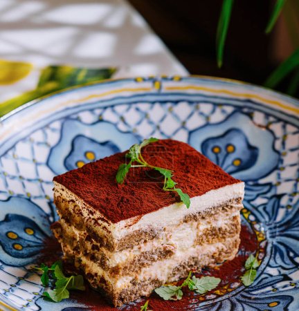 Piece of traditional italian Tiramisu dessert cake