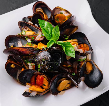 Delicious seafood mussels with with sauce and parsley