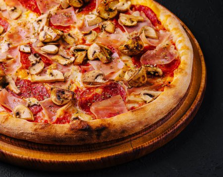 Photo for Pizza with ham, salami and mushrooms - Royalty Free Image