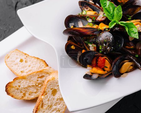 Delicious seafood mussels with with sauce and parsley