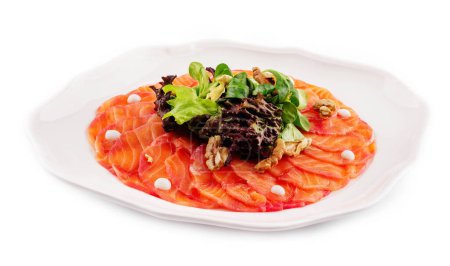 Salmon carpaccio with salad on plate