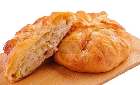 Baking puff pastry with fresh cabbage on wooden