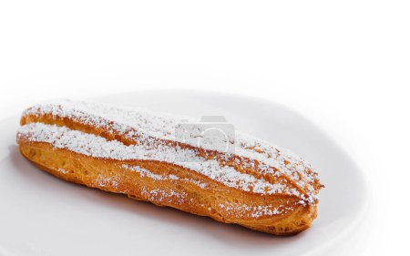 eclair with powdered sugar on a plate