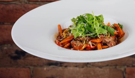 veal with carrots and arugula in plate