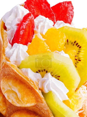 Bubble Waffle with kiwi, and whipped cream strawberry close up
