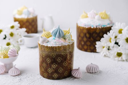 Handcrafted traditional easter cakes adorned with vibrant meringue on a festive table setting