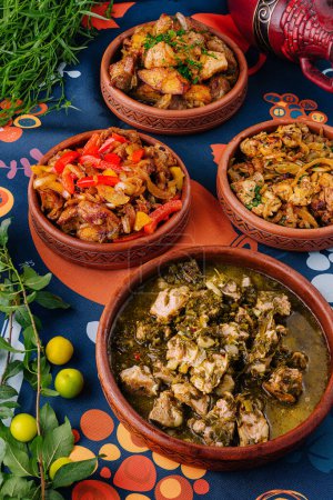 Colorful african cuisine with a variety of spicy stews in terracotta pots, garnished with herbs