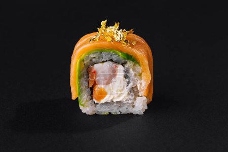 Luxurious sushi with gold leaf topping presented on a dark backdrop for an elegant culinary display