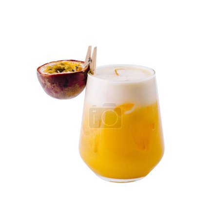 Elegant glass of tropical passion fruit cocktail with a slice garnish, isolated on a white background