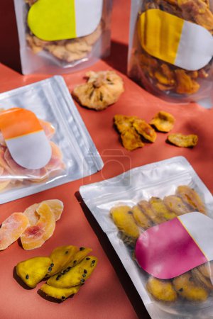 Colorful image featuring vacuum packaged dried fruits and meats on a vibrant background