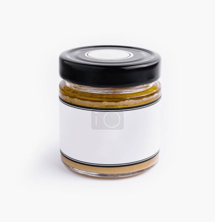 Empty glass jar with a black lid and blank label isolated on a white background