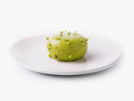 Sophisticated gourmet green apple dessert garnished with edible flowers, presented on a clean white plate