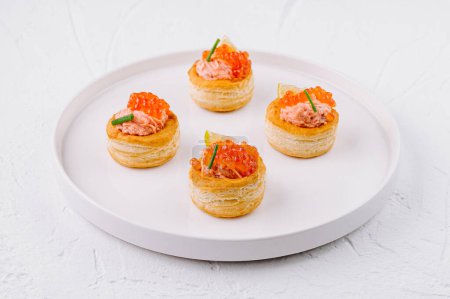 Photo for Gourmet puff pastry cups with salmon tartare and herbs, ready to serve on a white background - Royalty Free Image