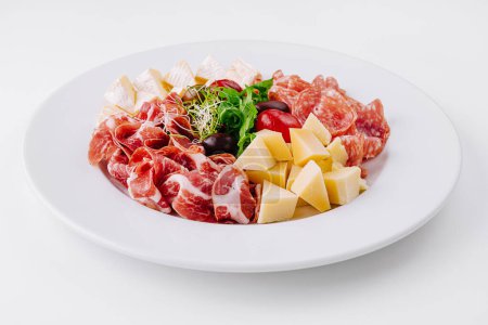Photo for Assorted deli meats and cheese cubes elegantly presented on a white plate - Royalty Free Image