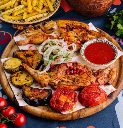 Vibrant dish of marinated grilled chicken, roasted vegetables, and spicy sauce, served on ethnic tableware