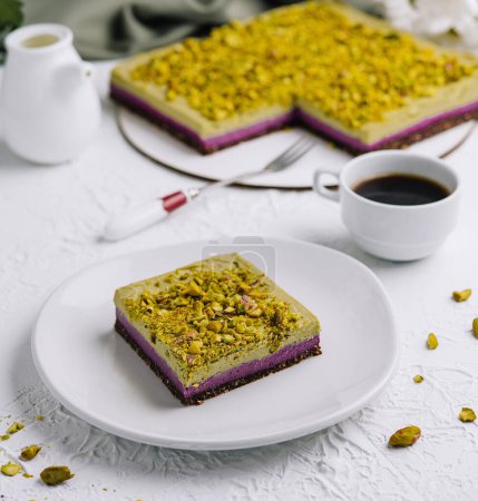 Tempting slice of pistachio cake paired with a fresh cup of coffee, elegant table setting