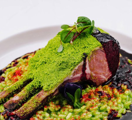 Exquisite roasted lamb rack with vibrant green herb crust and a rich berry reduction, served elegantly