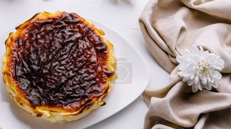 Delicious pastel de nata with a caramelized top, served on a white plate, surrounded by elegant table decor