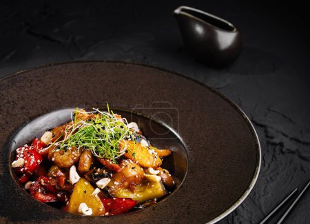 Elegant presentation of an asian-style stir-fried vegetable plate, garnished with microgreens