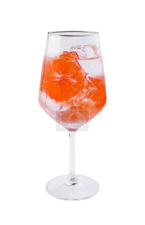 Crystal wine glass filled with a vibrant red beverage and ice, isolated on white
