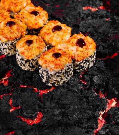 Artful presentation of a volcano sushi roll set on a dramatic black and red backdrop