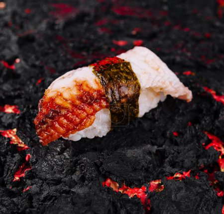 Artistic presentation of sushi on a textured charcoal backdrop, highlighting vibrant textures